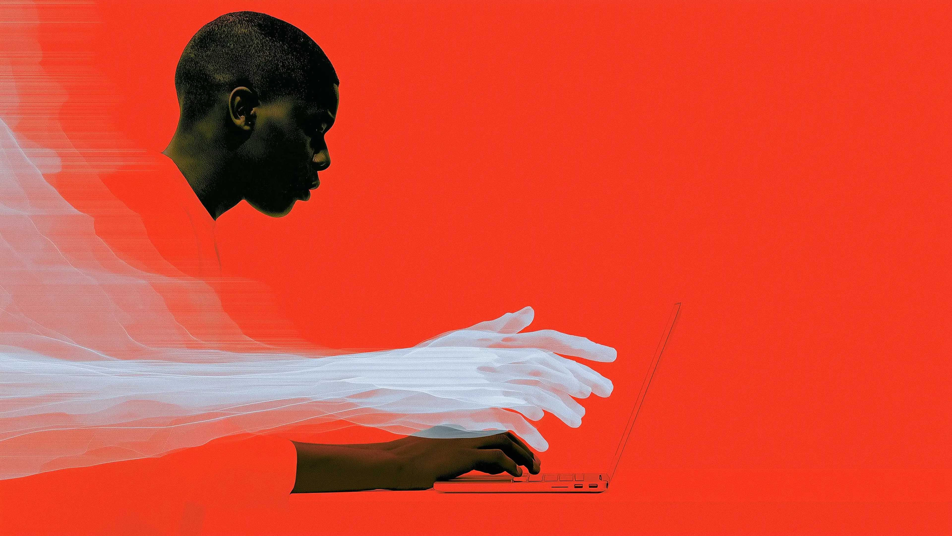 Person typing on a laptop against a vivid red background, suggesting focus or work on a digital task.
